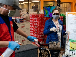 caption: Even without symptoms, you might have the virus and be able to spread it when out in public, say researchers who now are reconsidering the use of surgical masks.
