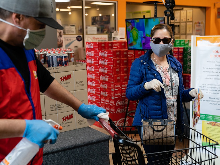 caption: Even without symptoms, you might have the virus and be able to spread it when out in public, say researchers who now are reconsidering the use of surgical masks.