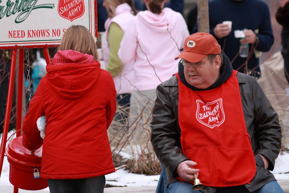 caption: A volunteer for the iconic Salvation Army Christmas bell ringing campaign.