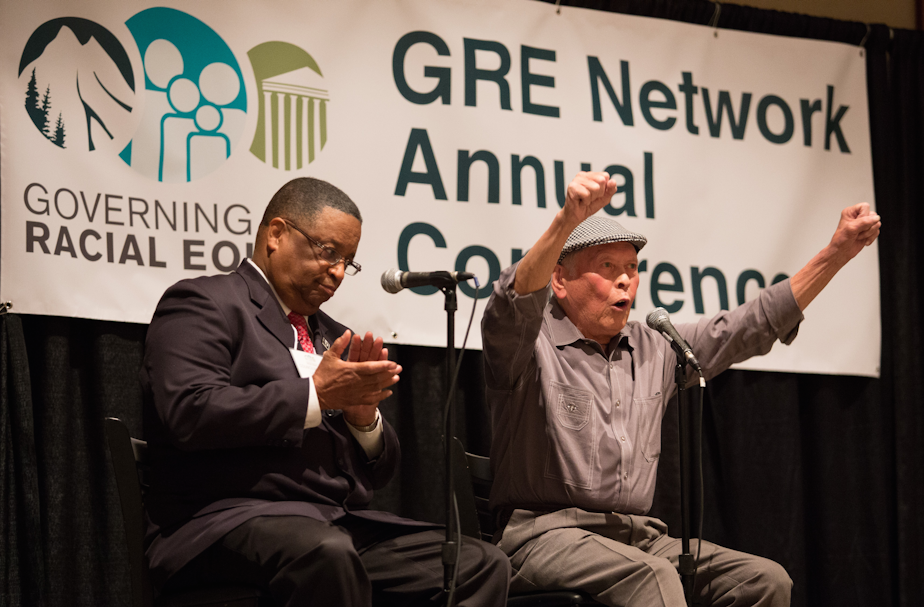 caption: Bob Santos (right) and Larry Gossett at a 2015 racial equity conference. Both men were part of the so-called "Gang Of Four" group of civil rights activists.
