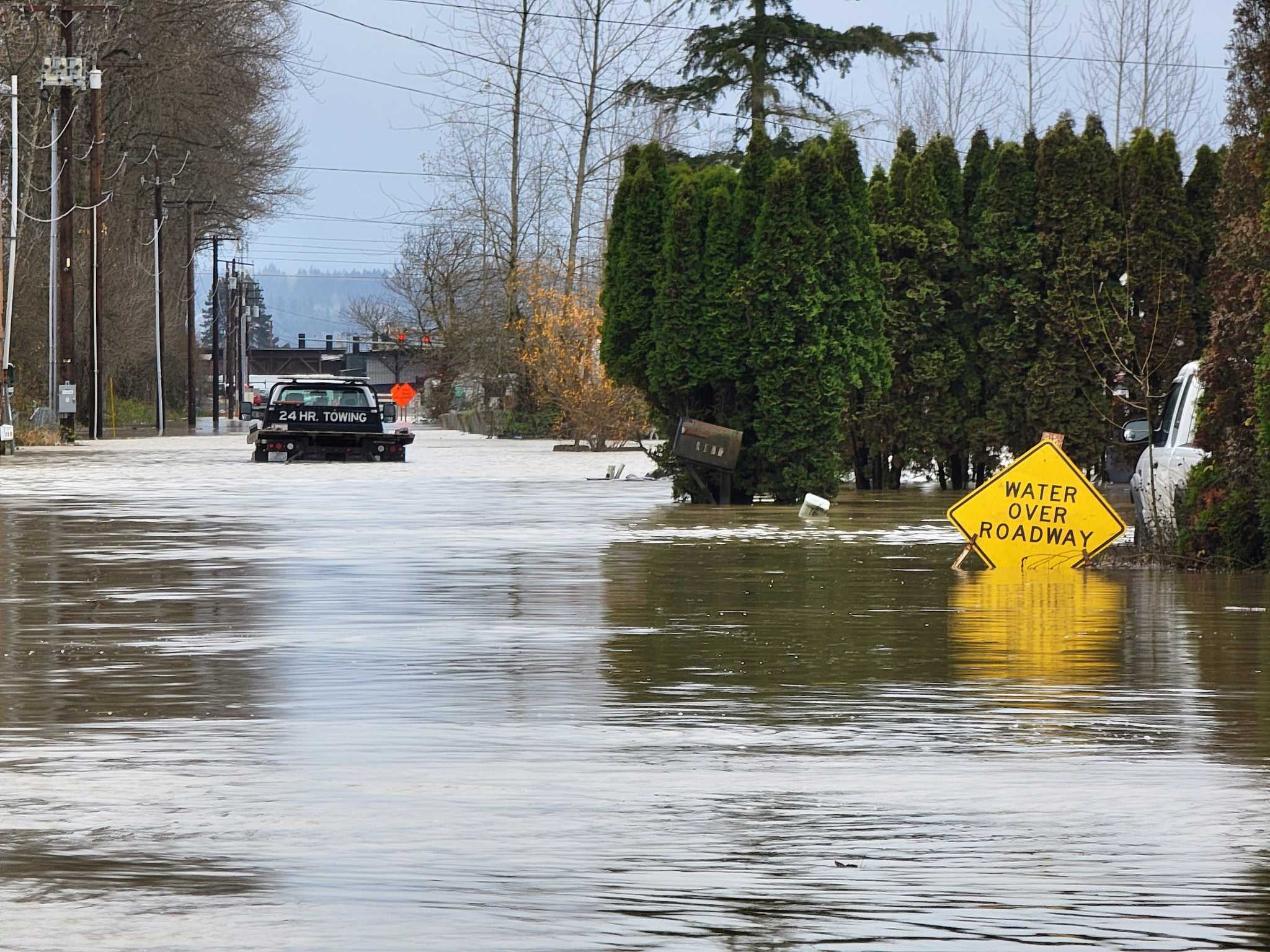 caption: A roadway is flooded Dec. 16, 2025, near the White River in Pacific, Washington.