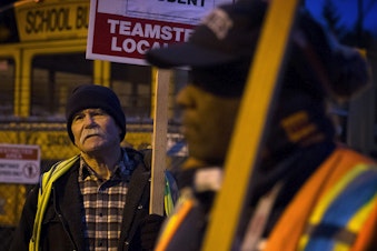 caption: Mike Browning, left, protests with other members of Teamsters Local 174 on Thursday, Feb. 1, 2018, outside of the First Student bus lot on Lake City Way Northeast in Seattle.