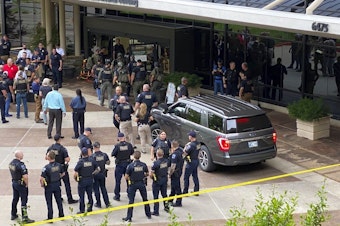 caption: Emergency personnel respond to a shooting at the Natalie Medical Building on Wednesday in Tulsa, Okla.