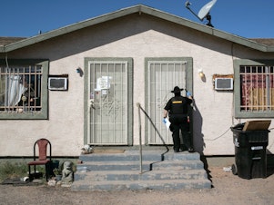 caption: Maricopa County constable Darlene Martinez knocks on a door before posting an eviction order on Oct. 1, 2020, in Phoenix. An extended eviction moratorium ordered by the Centers for Disease Control and Prevention is being challenged in court.