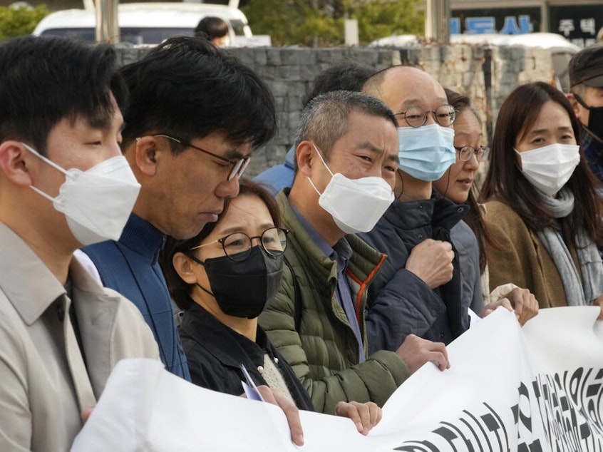 caption: Peter Møller, fourth from left, an attorney and co-founder of the Danish Korean Rights Group, attends a Nov. 15 press conference with a group of South Korean adoptees in front of the Truth and Reconciliation Commission in Seoul, South Korea. Seoul faces growing pressure to reckon with the child export frenzy driven by dictatorships that ruled the country until the 1980s.