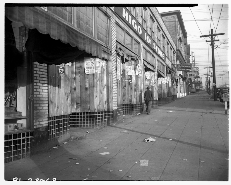 caption: Seattle Japantown's Higo 10 Cent Store, pictured here in April 1942, was boarded up for the duration of the war. The building's Jewish tenants watched and managed the building until the owners of the store -- Sanzo and Matsuyo Murakami -- returned from incarceration.

Photo courtesy of the Museum of History and Industry