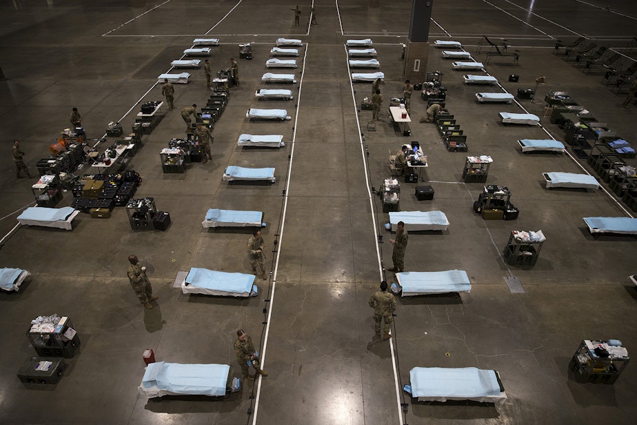caption: U.S. Army soldiers from the 627th Army Hospital from Fort Carson, Colorado, as well as from Joint Base Lewis-McChord set up a military field hospital on Tuesday, March 31, 2020, at the CenturyLink Field Event Center in Seattle. The 250-bed hospital will be for non COVID-19 patients. 