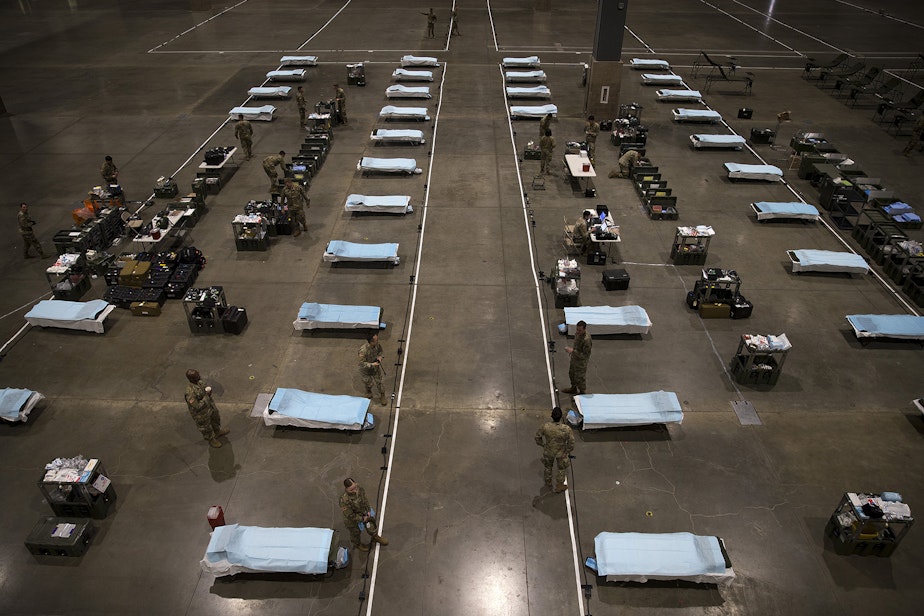 caption: U.S. Army soldiers from the 627th Army Hospital from Fort Carson, Colorado, as well as from Joint Base Lewis-McChord set up a military field hospital on Tuesday, March 31, 2020, at the CenturyLink Field Event Center in Seattle. The 250-bed hospital will be for non COVID-19 patients.