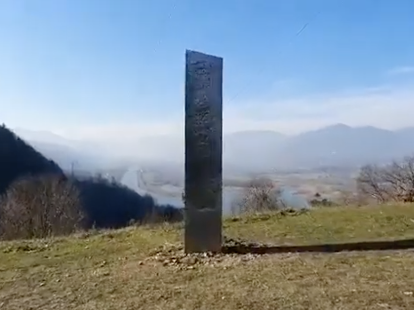 caption: A metal monolith was reported to have appeared on a scenic location in northern Romania on Nov. 27. Local newspaper Ziar Piatra Neamt reported the finding on a hill near the archaeological site of an old fortress overlooking the Bâtca Doamnei lake.