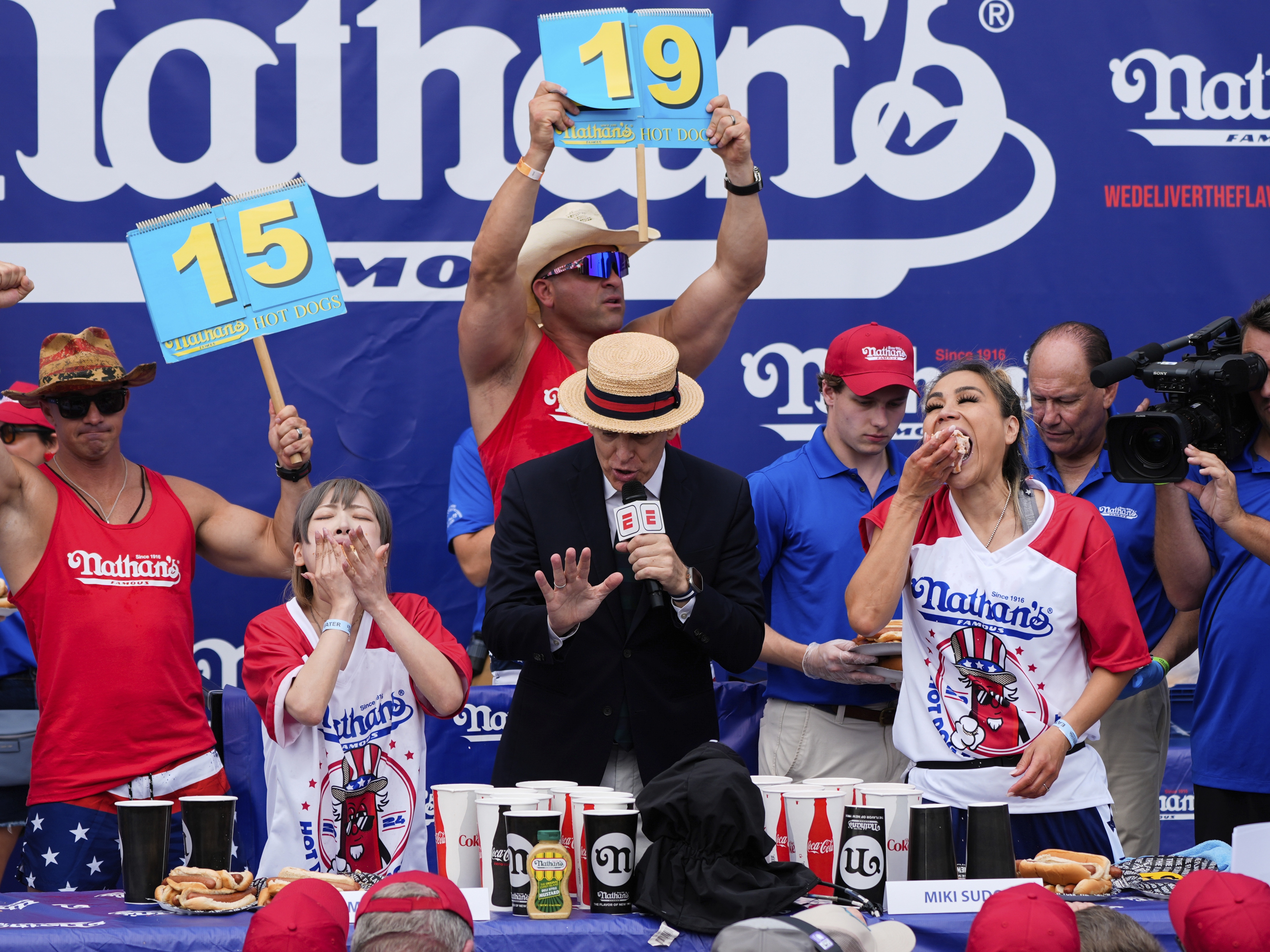 caption: Miki Sudo (right) and Mayoi Ebihara compete in the women's division of Nathan's Famous Fourth of July hot dog eating contest, Thursday, at Coney Island in the Brooklyn borough of New York. Sudo won by eating a record 51 hot dogs.