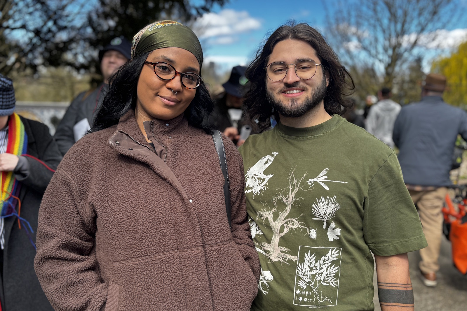 caption: Bruno DeMelo Batista and Shavon Hicklin in line to board the train at Judkins Park Station on opening day, March 28, 2026