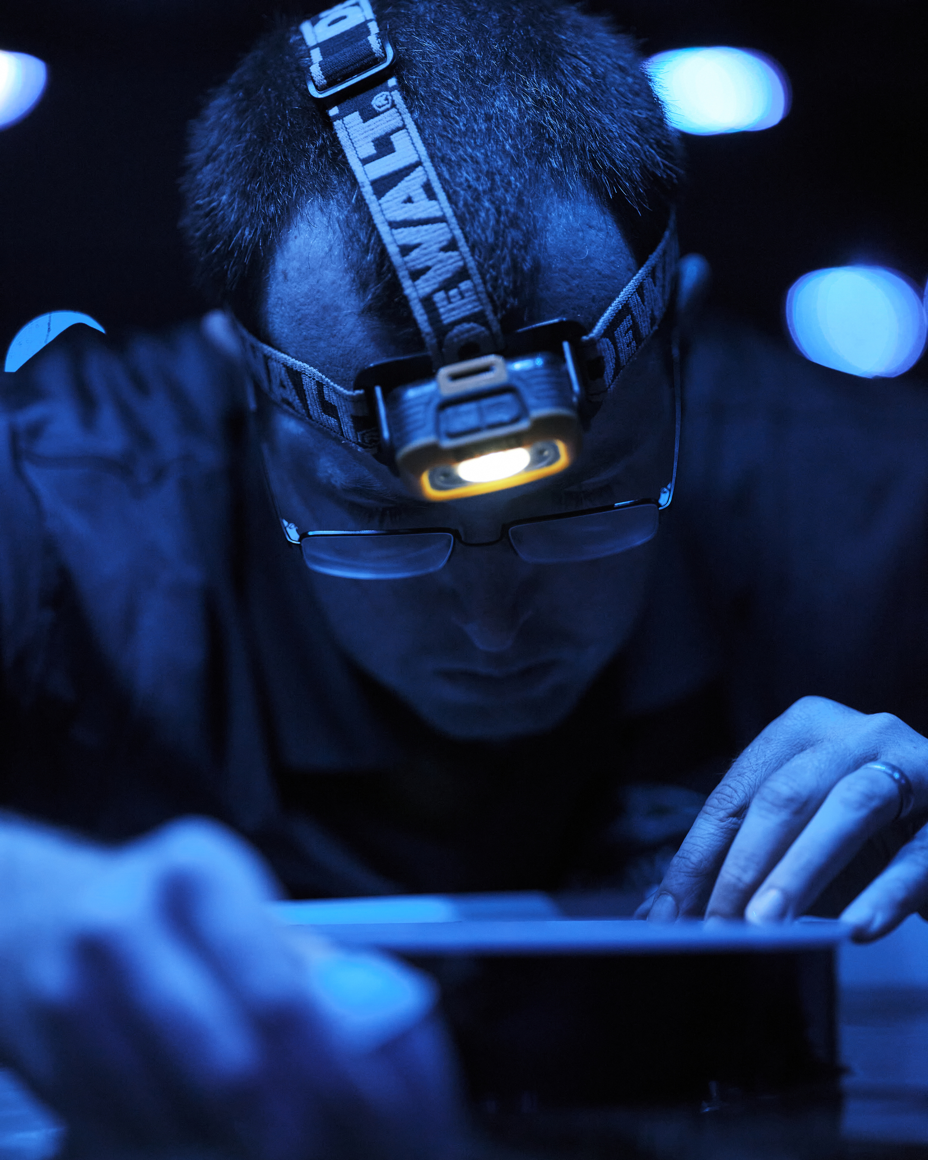 caption: Kevin Davenport, an aquarist and coral biologist, feeds krill to growing corals, in a warehouse for growing and rehabilitating coral populations.