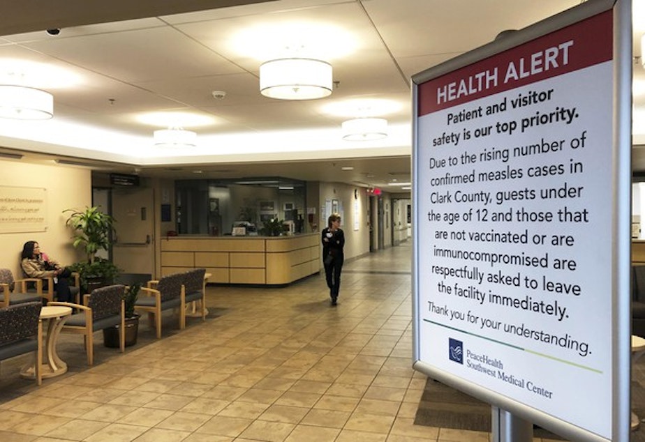 <p>In this Jan. 25, 2019, file photo, a sign prohibiting all children under 12 and unvaccinated adults stands at the entrance to PeaceHealth Southwest Medical Center in Vancouver, Washington.</p>