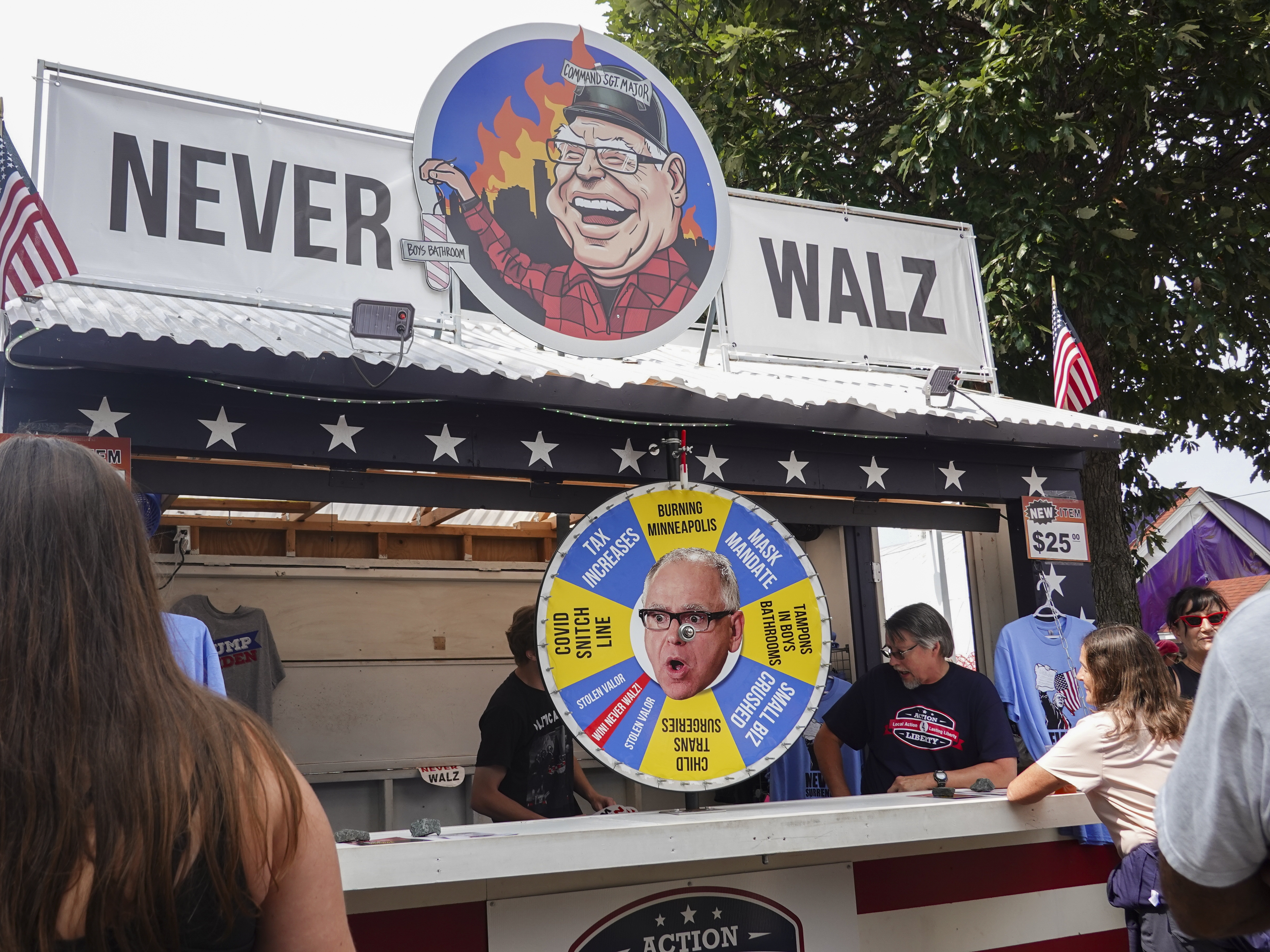 caption: Action 4 Liberty, a conservative group in the state, runs a stand at the Minnesota State Fair opposing Democratic Minnesota Gov. Tim Walz.