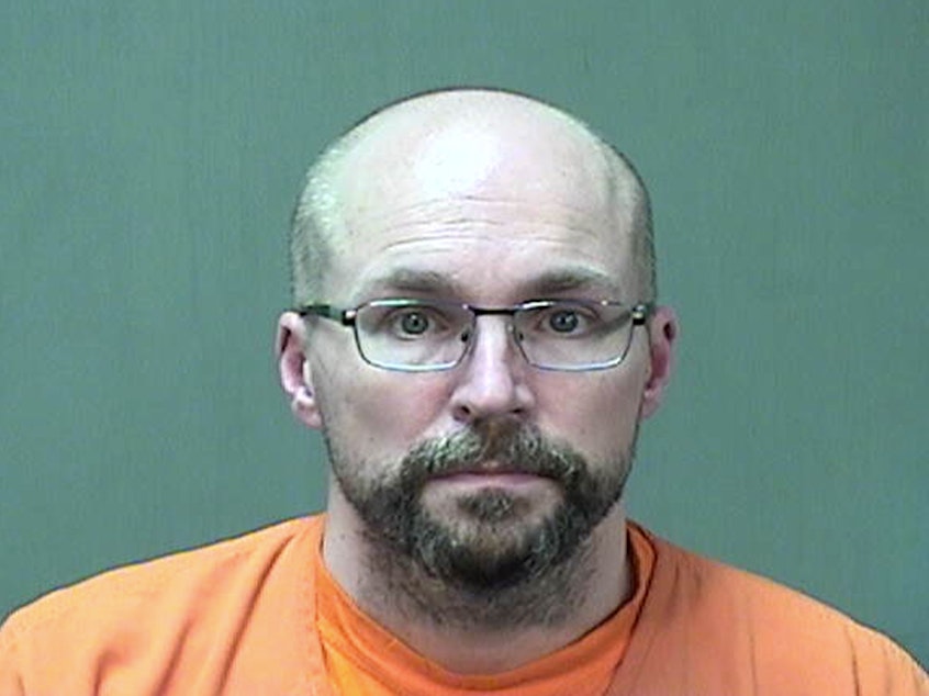 caption: Steven Brandenburg at the Ozaukee County Sheriff's Office Monday, in Port Washington, Wis. Brandenburg agreed to plead guilty to two charges of of attempting to tamper with consumer products with reckless disregard for the risk that another person will be placed in danger of death or bodily injury, prosecutors say.