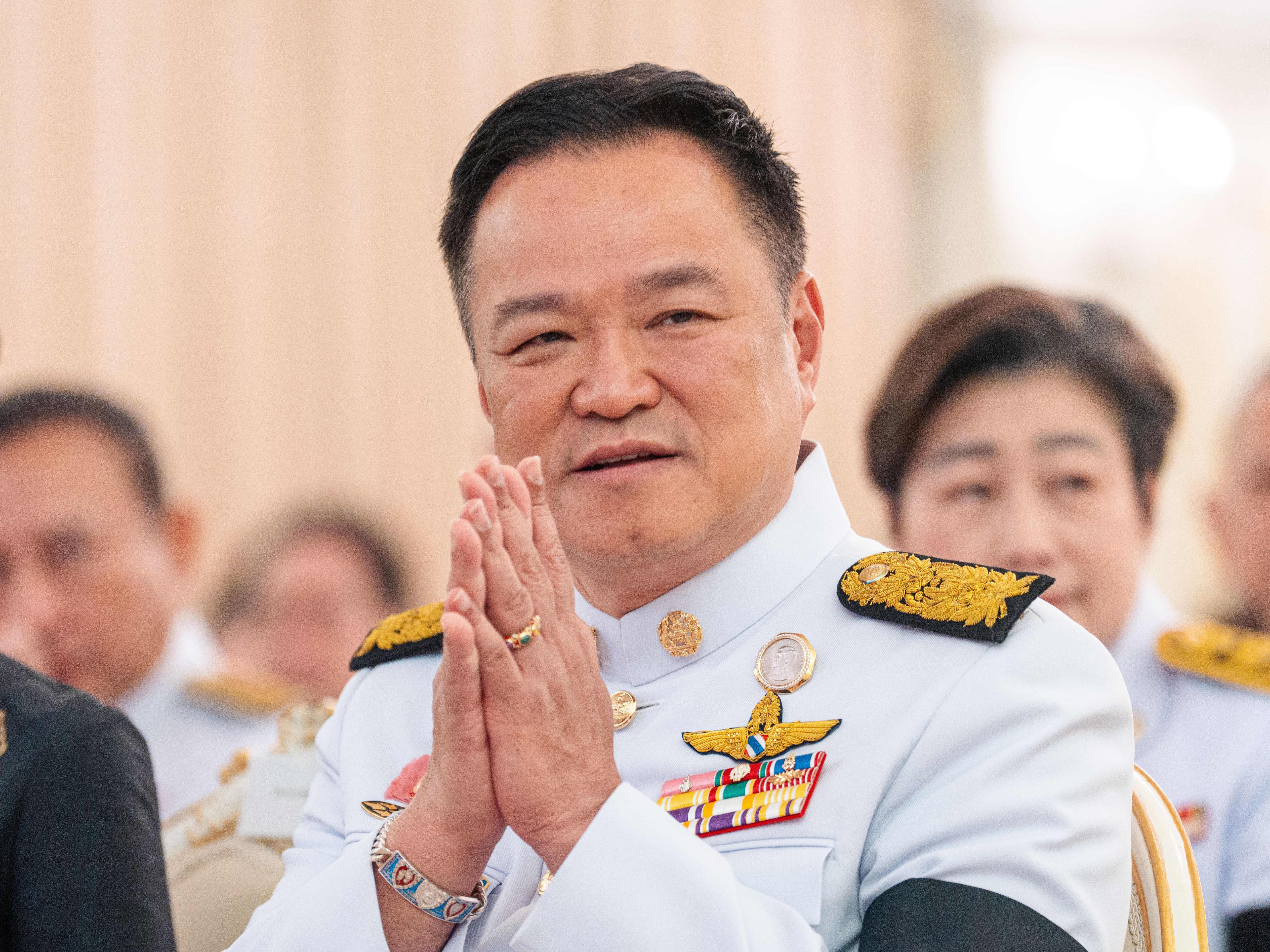 caption: Thailand's Prime Minister Anutin Charnvirakul gestures as he attends an event at the government house in Bangkok, Thailand, Friday, Dec. 12, 2025.