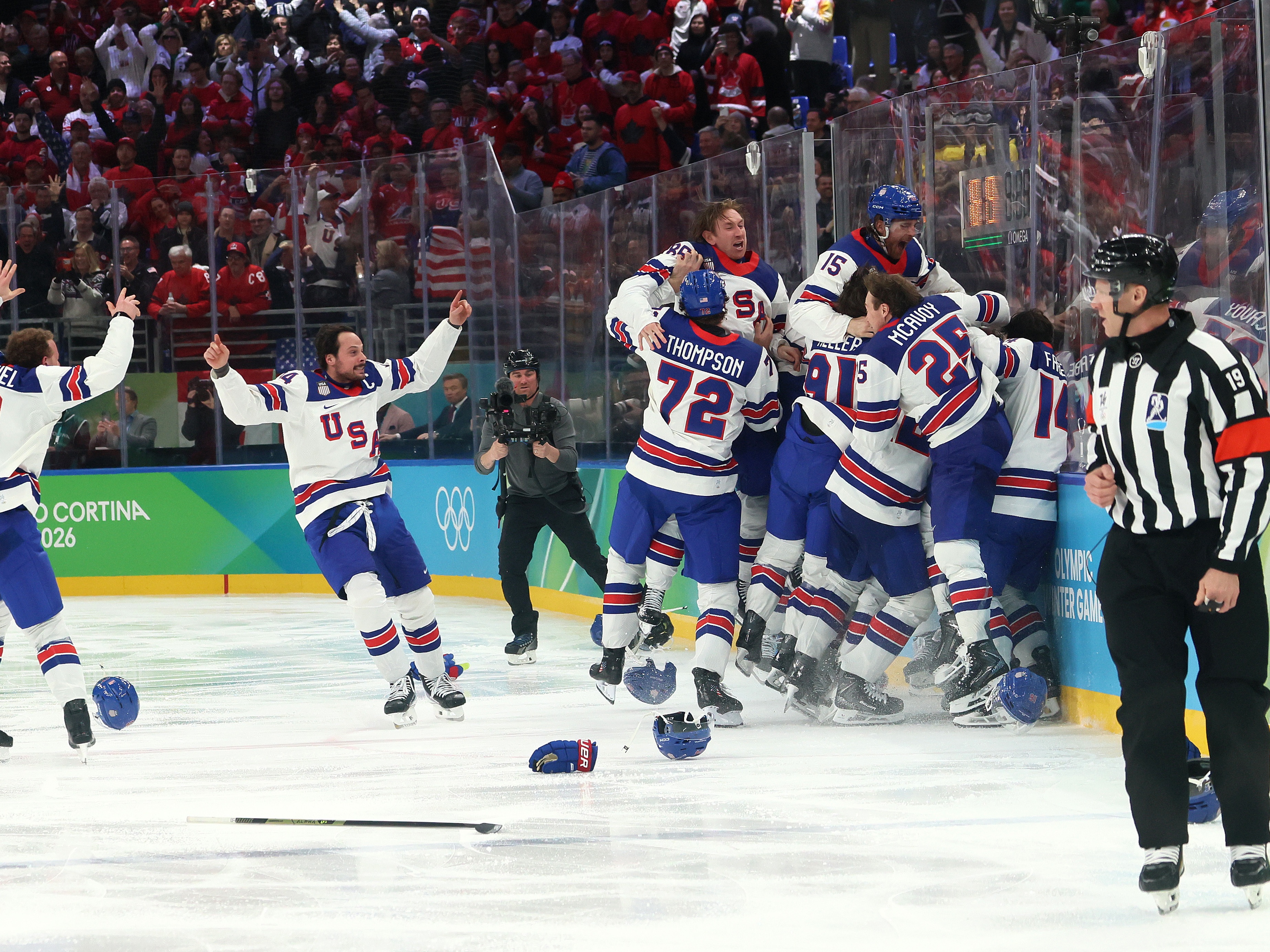 caption: MILAN, ITALY - FEBRUARY 22: Jack Hughes #86 of Team United States celebrates with teammates after scoring the game-winning goal in overtime during the Men's Gold Medal match between Canada and the United States on day 16 of the Milano Cortina 2026 Winter Olympic games at Milano Santagiulia Ice Hockey Arena on February 22, 2026 in Milan, Italy.