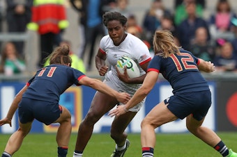 caption: Naya Tapper of the USA is tackled by Camille Grassineau (left) and Elodie Poublan of France during the 2017 Women's Rugby World Cup third-place match in Belfast. The U.S. will host the women's tournament for the first time in 2033.