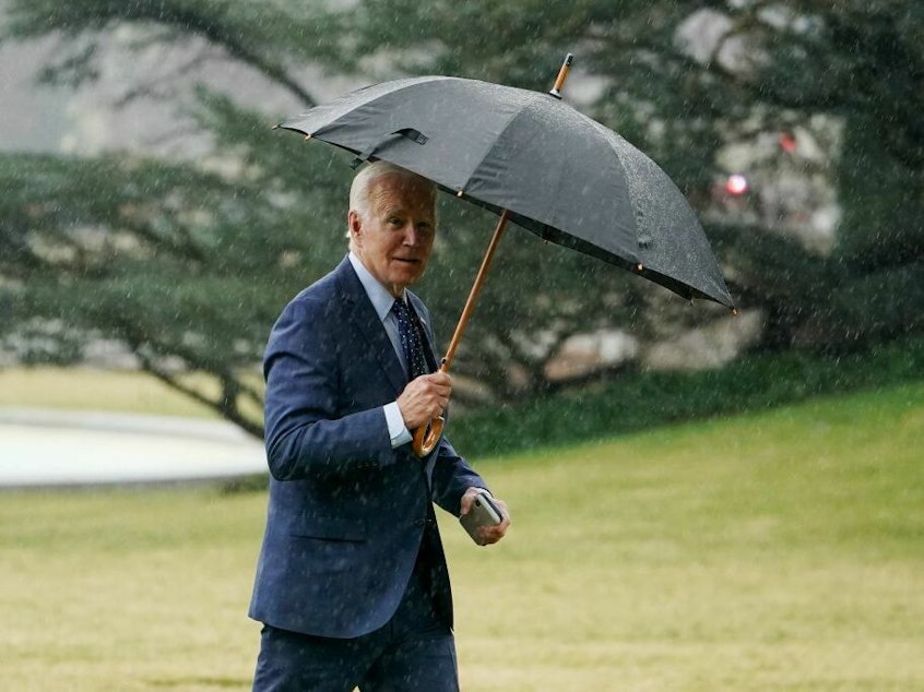 caption: President Biden walks across the South Lawn upon return to the White House on Thursday.