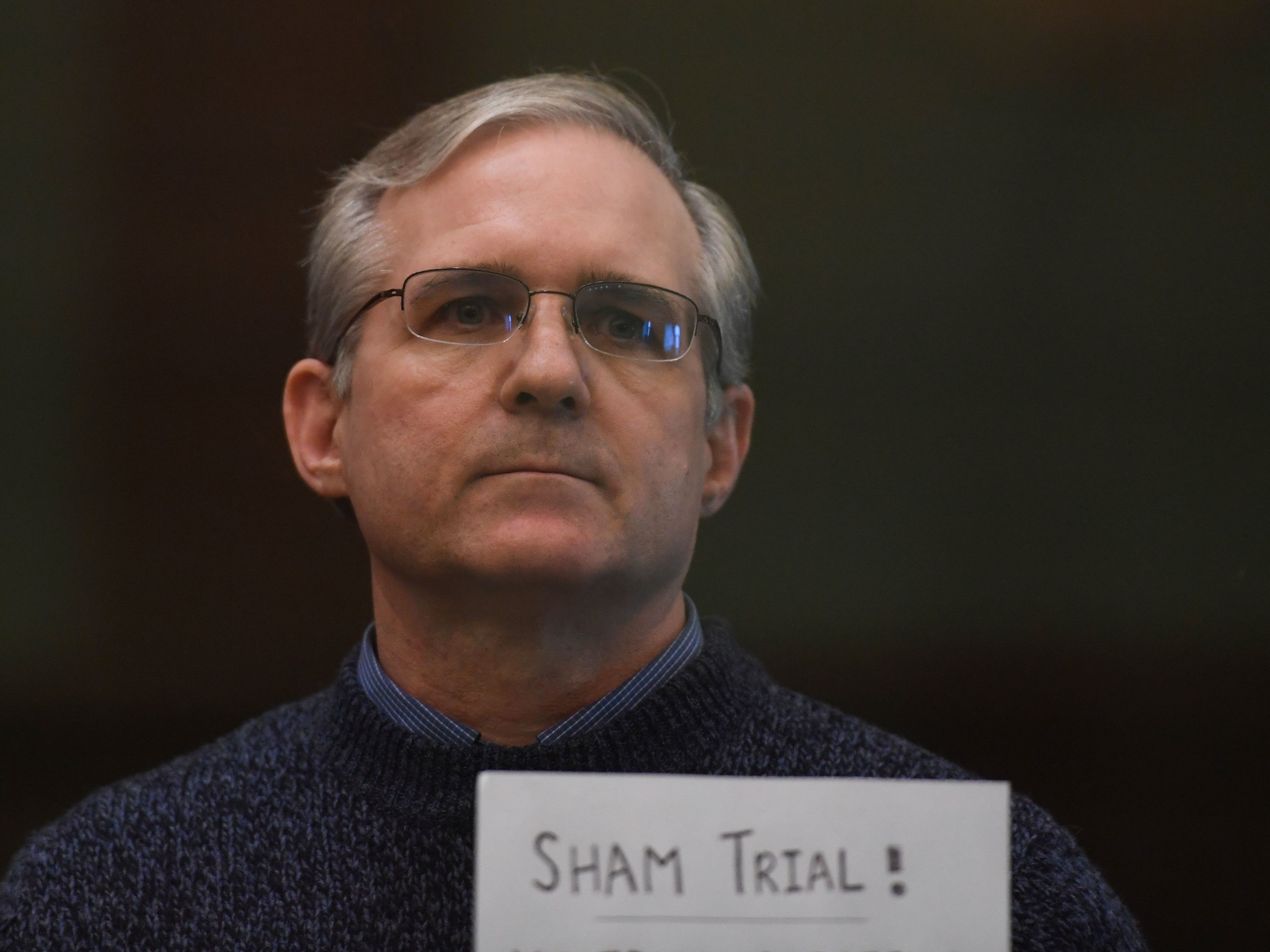 caption: Paul Whelan holds a sign in protest as he awaits his verdict in Moscow in June 2020. He was sentenced to 16 years in prison on charges of espionage.