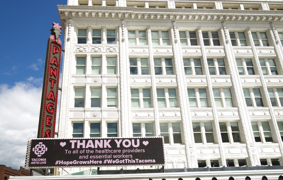 caption: The digital message board on the Pantages Theater in Tacoma. The theater is one of the venues for Tacoma Arts Live, which will be offering arts education summer camps over Zoom this year. Pierce County has seen more than 2,000 confirmed cases of COVID-19, ranking fourth in the state behind King, Yakima, and Snohomish Counties.