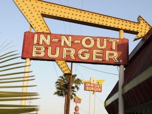 caption: In-N-Out is barring employees in five states from wearing masks unless they have a doctor's note, according to internal company emails leaked on social media last week. An In-N-Out Burger signs is seen on June 8, 2010, in Baldwin Park, Calif.