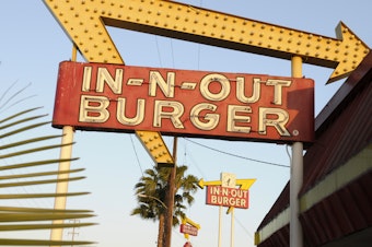 caption: In-N-Out is barring employees in five states from wearing masks unless they have a doctor's note, according to internal company emails leaked on social media last week. An In-N-Out Burger signs is seen on June 8, 2010, in Baldwin Park, Calif.