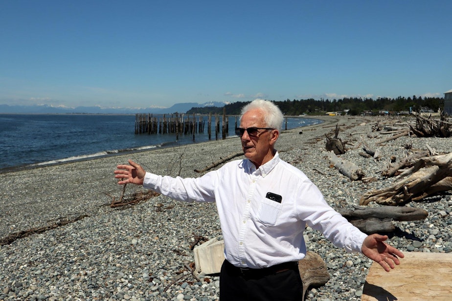 caption: Point Roberts Chamber of Commerce President Brian Calder at a beach left deserted by cross-border travel restrictions.
