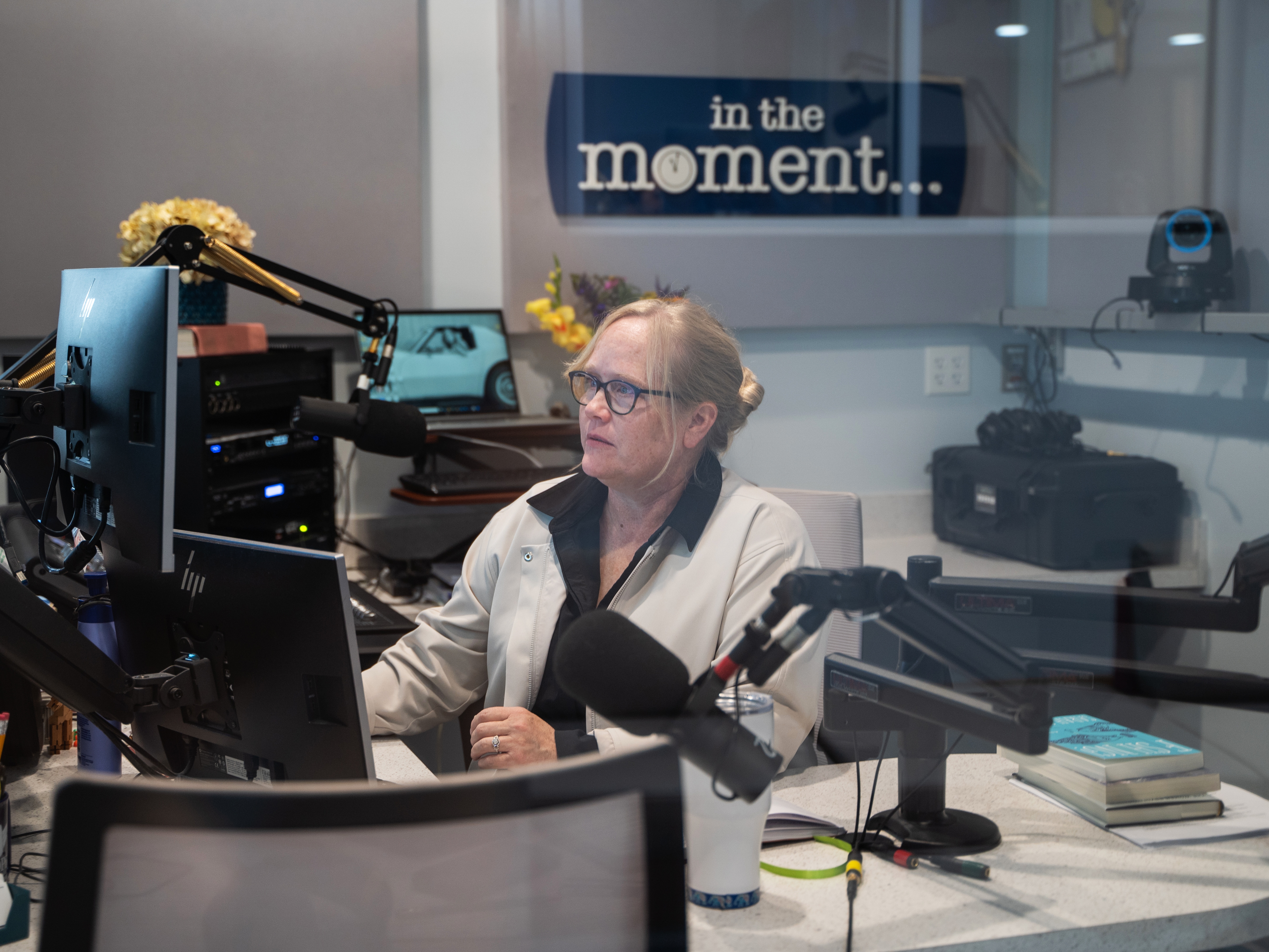 caption: Lori Walsh hosts the soon-to-be canceled <em>In the Moment</em>, which currently plays three times a day<em>. </em>