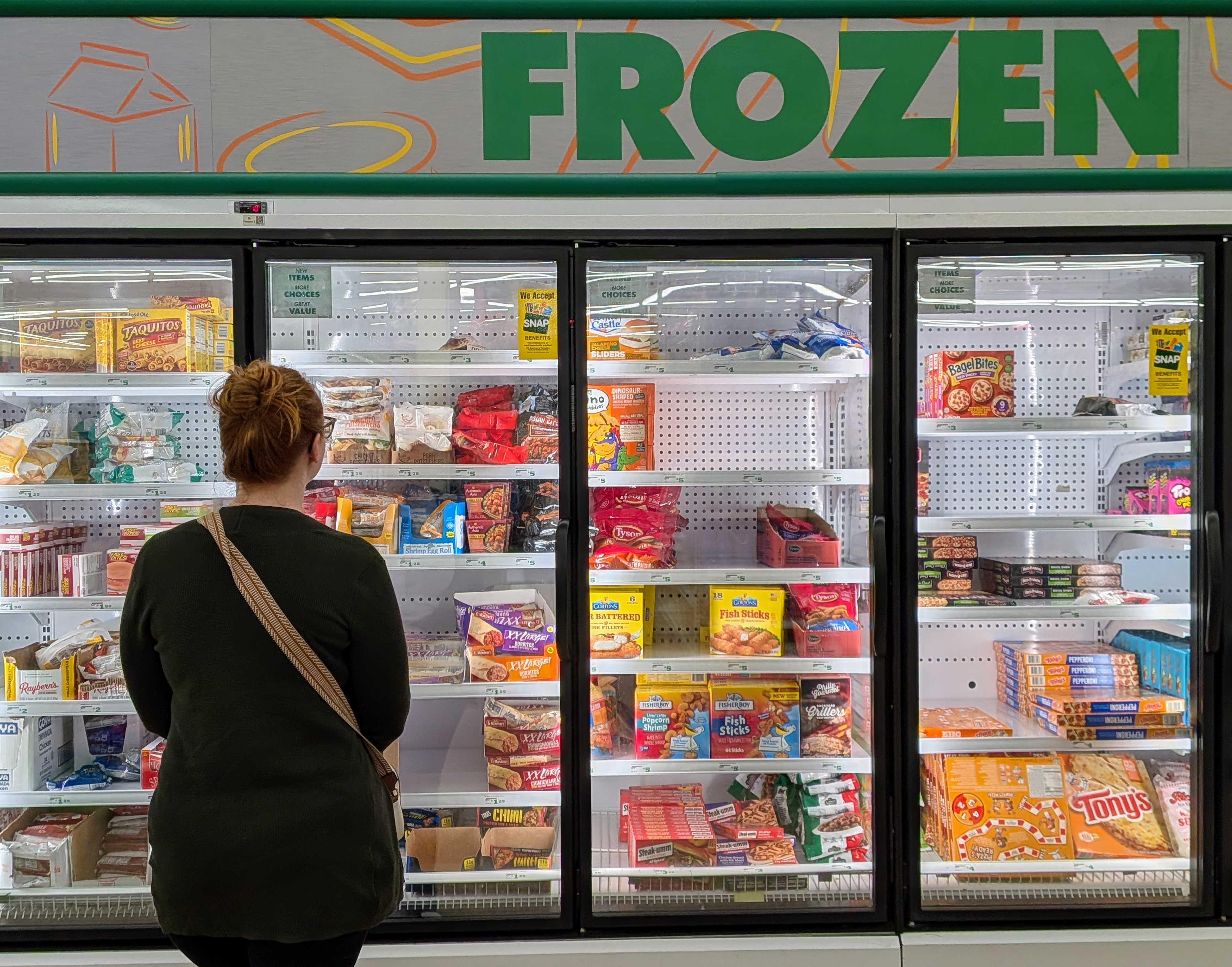 caption: Rebecca Chobat shops for groceries at a Dollar Tree in Arlington, Wash.