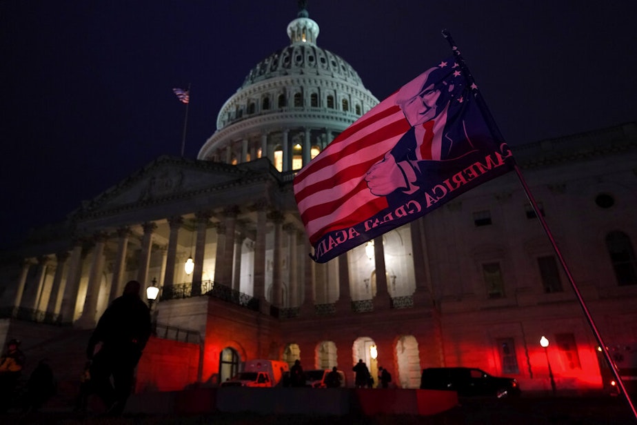 caption: Authorities stand guard outside the U.S. Capitol after supporters of President Donald Trump gathered Wednesday, Jan. 6, 2021, in Washington. 