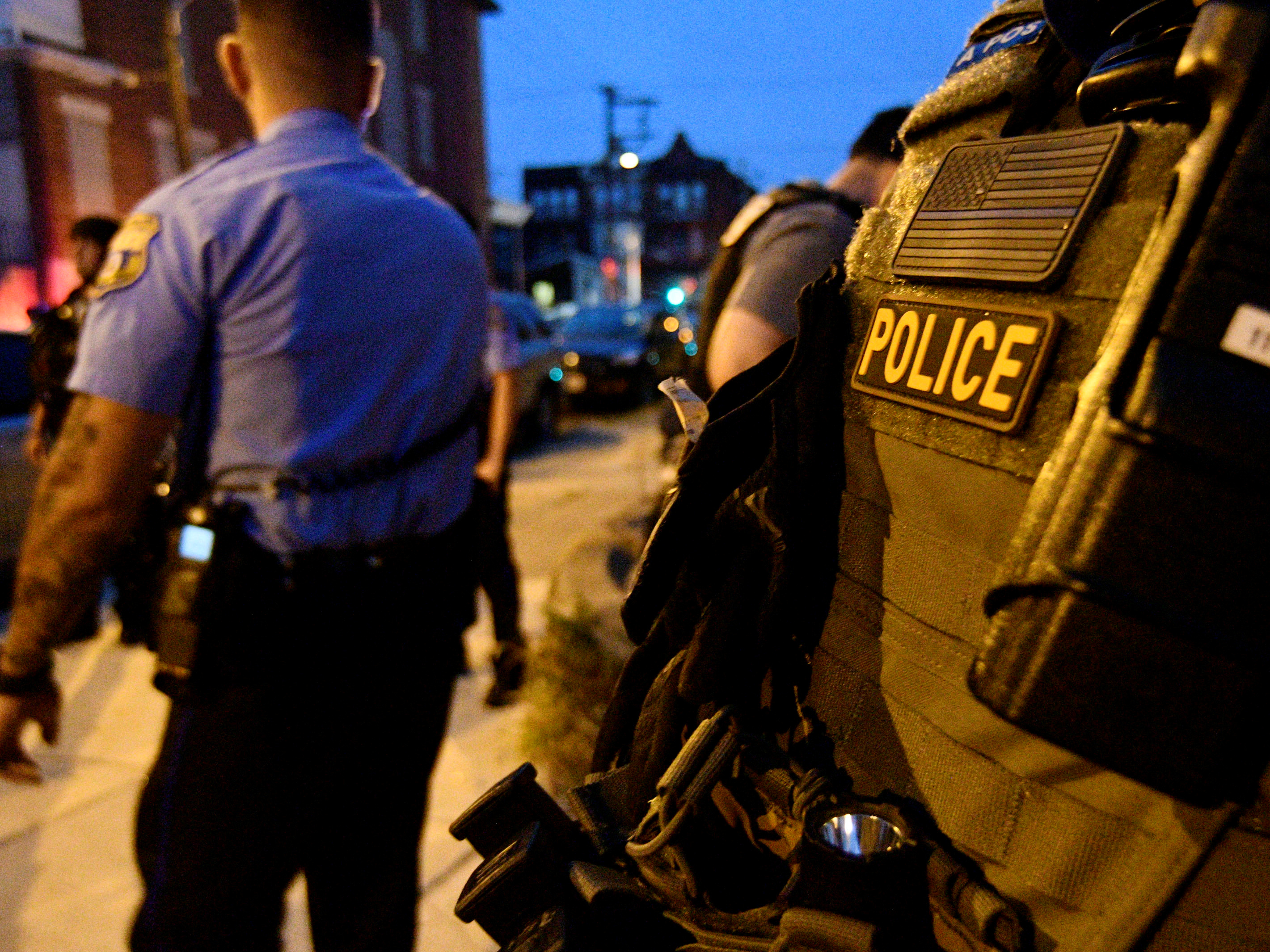 caption: Police surround a home in North Philadelphia where a gunman wounded officers who tried to serve a drug warrant.