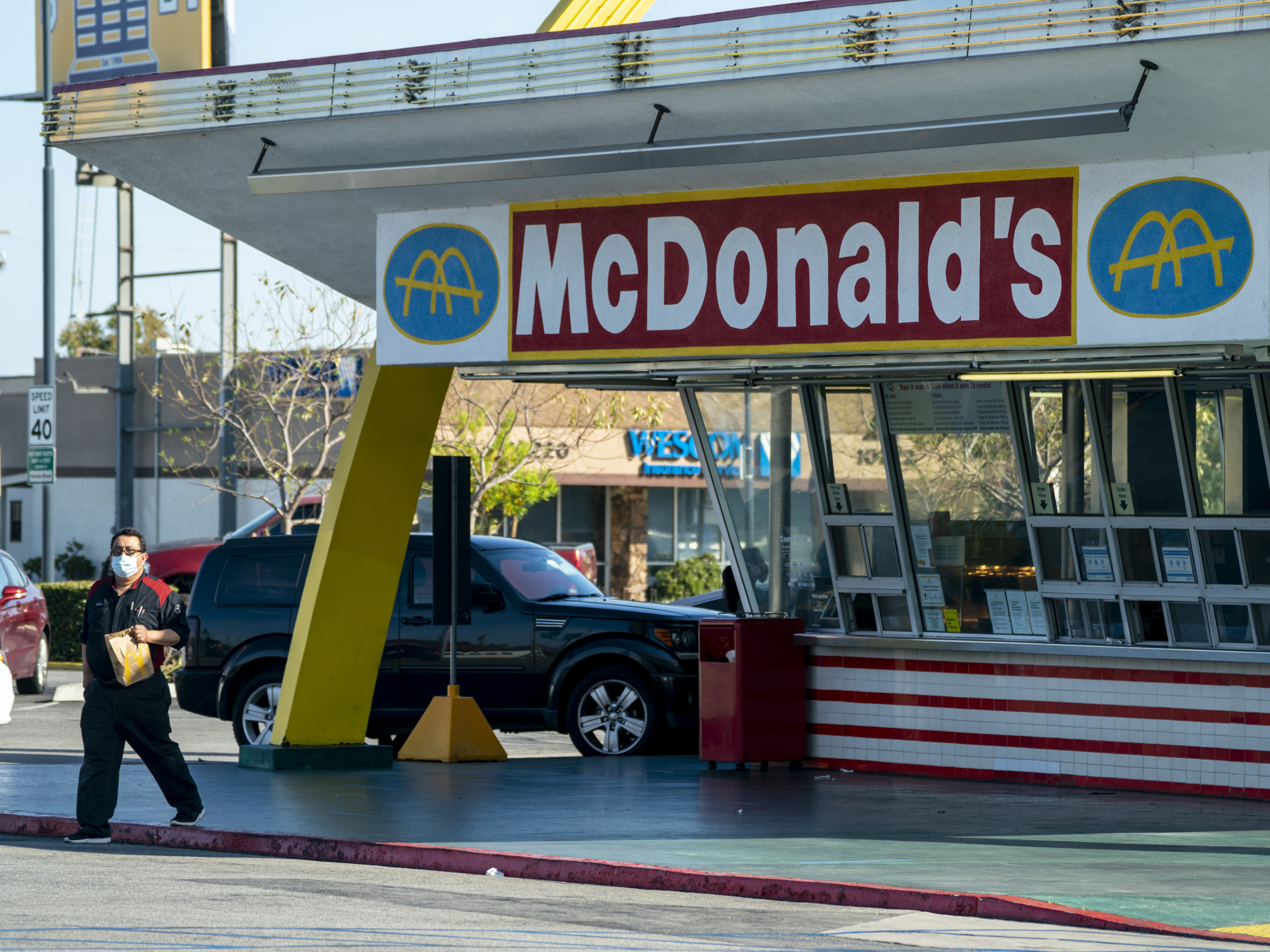 caption: McDonald's will require all customers at its U.S. restaurants to wear a face mask, the company said Friday. Here, a customer wears a mask after picking up an order at the oldest operating McDonald's Corp. restaurant, in Downey, Calif., in April.