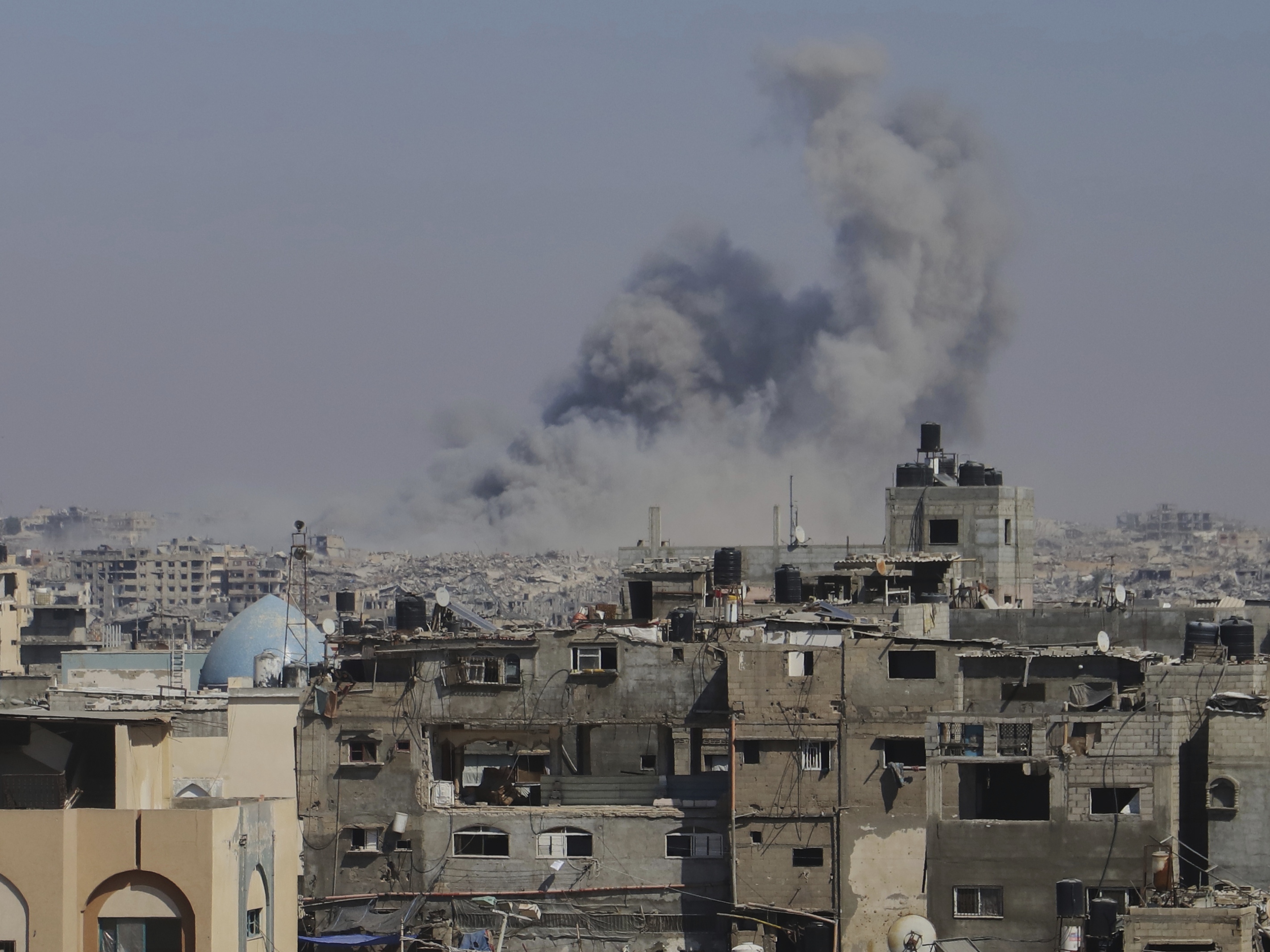 caption: Smoke rises to the sky following an Israeli army airstrike in Khan Younis in the Gaza Strip on Aug. 18, 2025.