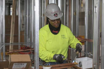 caption: Plumber Zakiyyah Askia welds pipes at a high-rise residence under construction in Chicago on Jan. 24. U.S. employers added 196,000 jobs in March, a rebound from February's weak growth, the Labor Department said Friday.