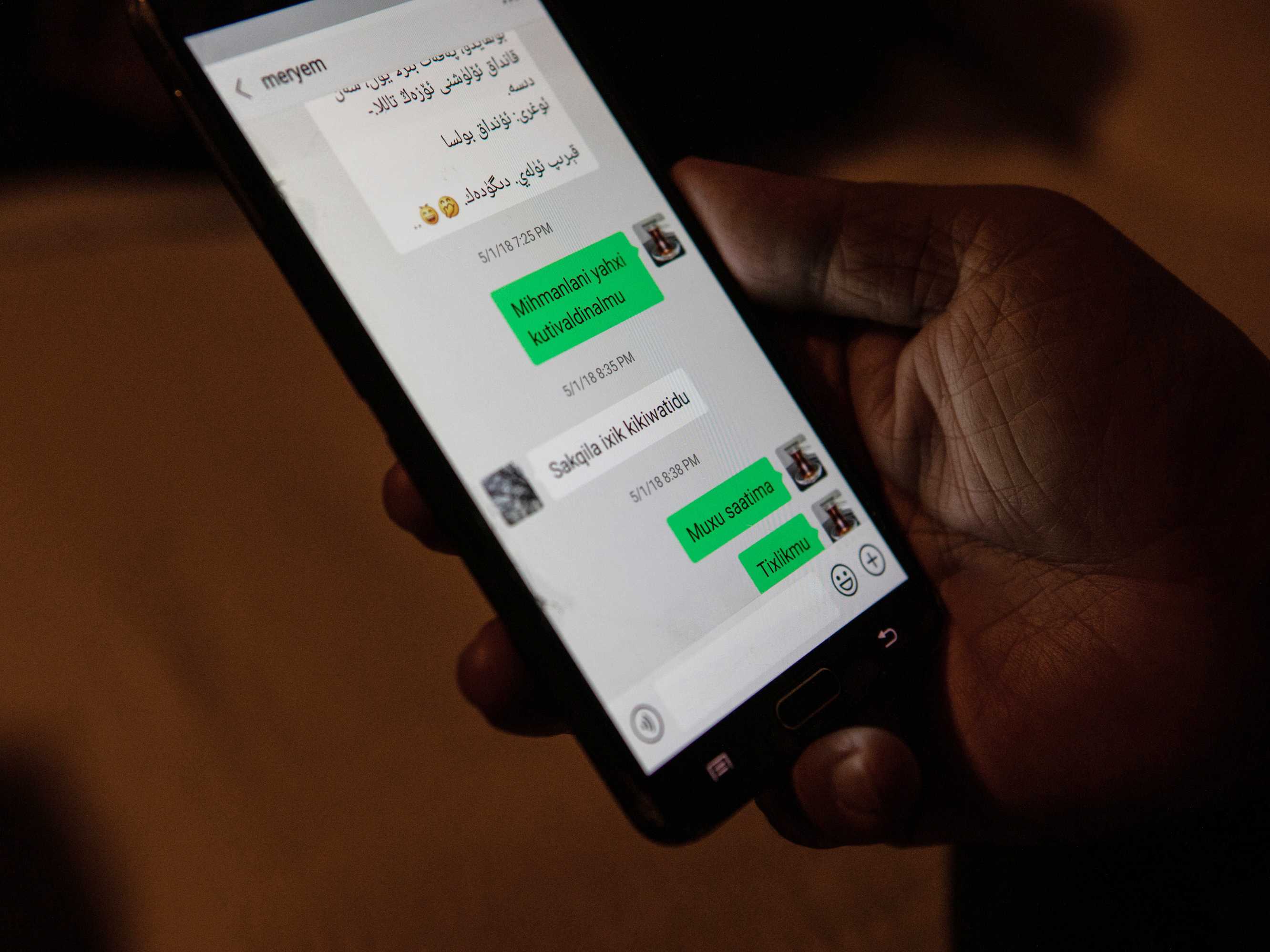 caption: Kuçar shows text messages he exchanged with his wife Meryem Aimati the night she was detained from her home in Xinjiang. "The police are at the door," she wrote.