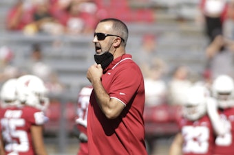 caption: Washington State University head coach Nick Rolovich speaks to his players before an NCAA college football game against Portland State on Sept. 11, 2021, in Pullman, Wash.