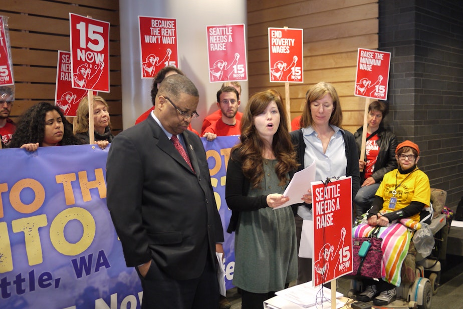 caption: King County Council Member Larry Gossett and Vote 15 campaign manager Jess Spear at the launch of 15Now's charter amendment in early April.