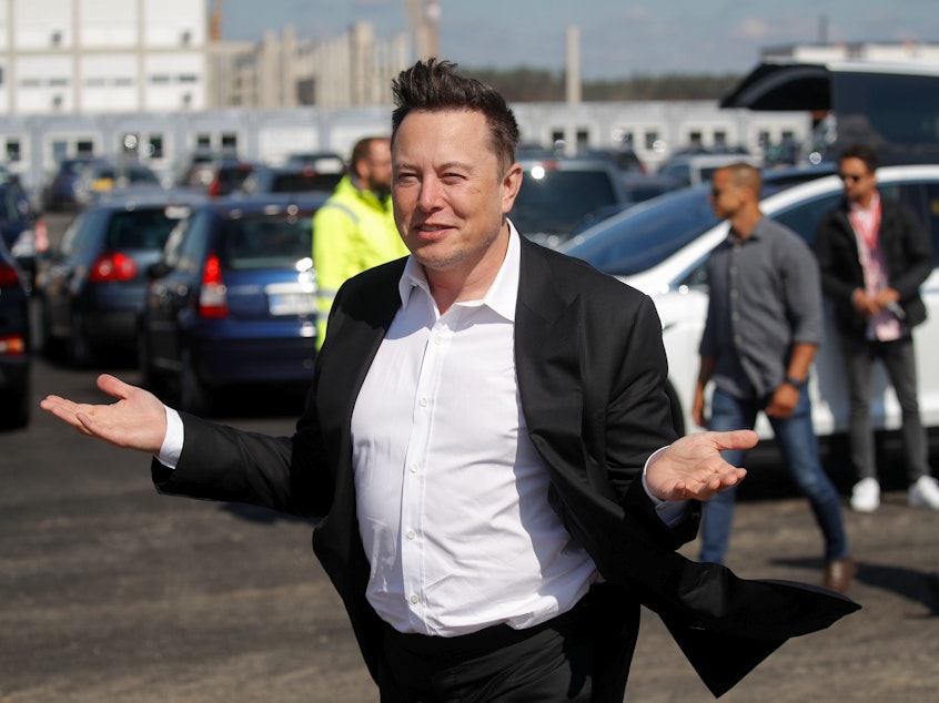 caption: Tesla CEO Elon Musk gestures as he arrives to visit the construction site of a future Tesla plant near Berlin on Sept. 3. Musk is now the world's second-richest person, according to Bloomberg.
