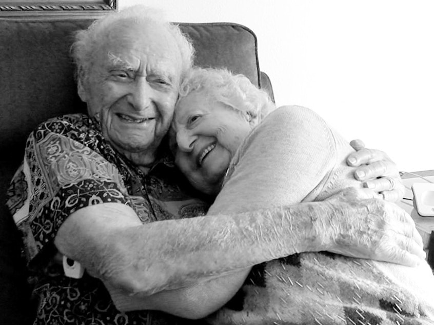 caption: Joe Newman, 107, hugs his fiancée, Anita Sampson, who recently celebrated her 100th birthday with a party over Zoom.