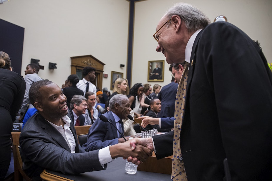 caption: Writer Ta-Nehisi Coates shakes hands with House Subcommittee Chairman Steve Cohen, D-Tenn., during a hearing on slavery reparations held by the House Judiciary Subcommittee on the Constitution, Civil Rights and Civil Liberties on June 19, 2019 in Washington, D.C. (Zach Gibson/Getty Images)