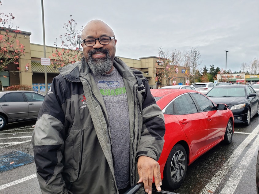 caption: Jessie Ramsey talks politics in the Kent Safeway parking lot on Sunday, November 17, 2024.