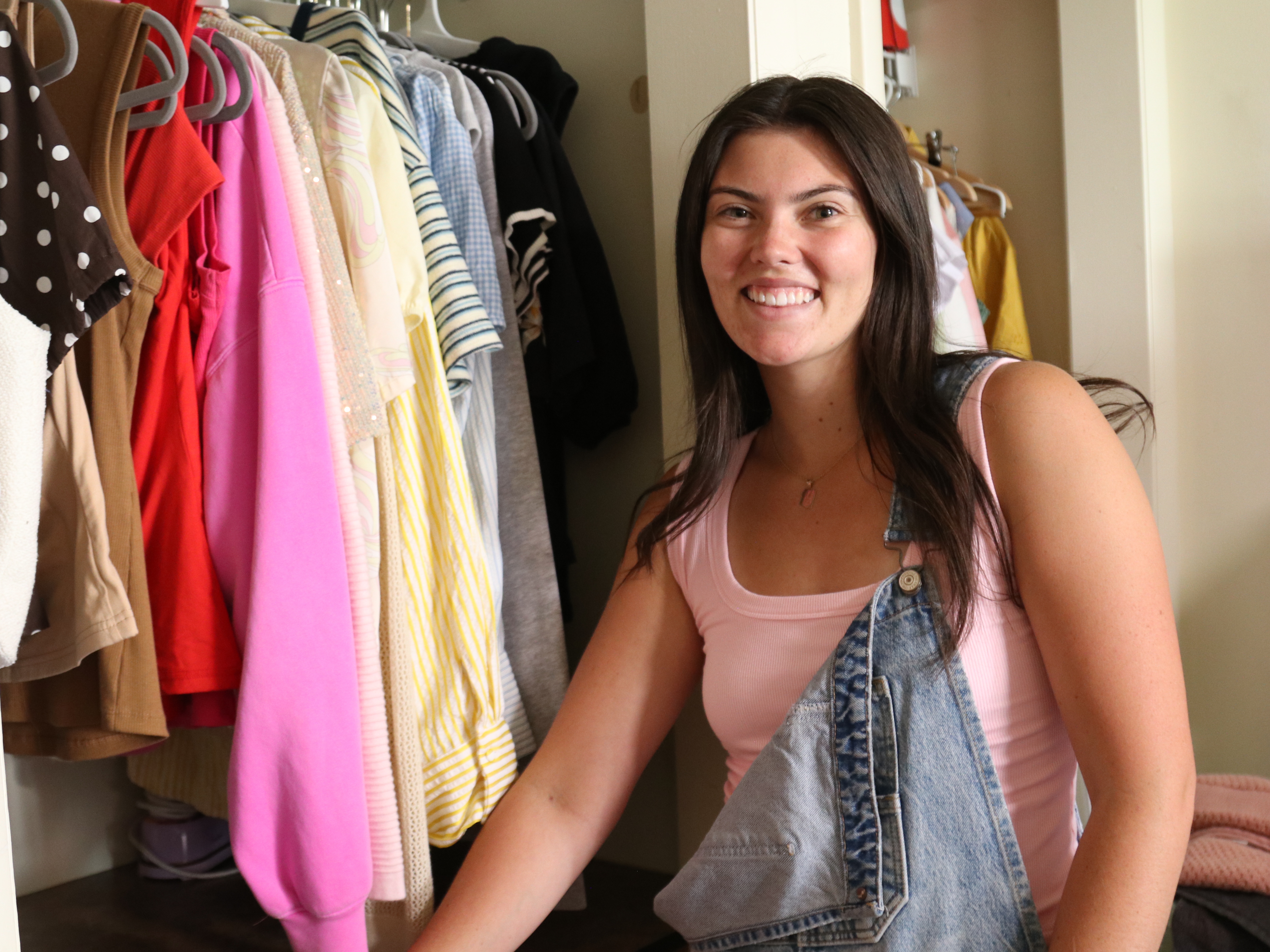 caption: Brigham Young University student Dara Layton, a Mormon, shows the new clothes she can wear since The Church of Jesus Christ of Latter-day Saints made changes to its sacred undergarments.