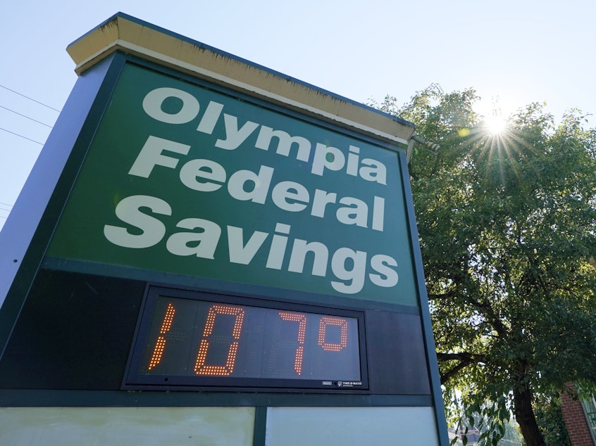 caption: A display at an Olympia Federal Savings branch shows a temperature of 107 degrees Fahrenheit on Monday in the early evening in Olympia, Wash.