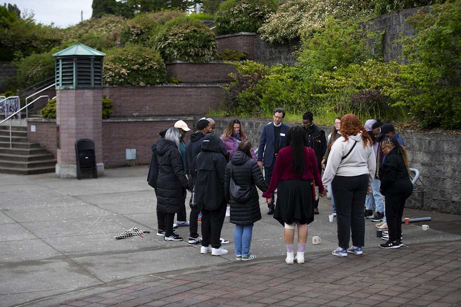 caption: Parents and community members form a prayer circle ahead of welcoming students back to Garfield high school for the first time following the fatal shooting of their 17-year-old classmate, Amarr Murphy, on Tuesday, June 11, 2024, at Garfield High School in Seattle. 