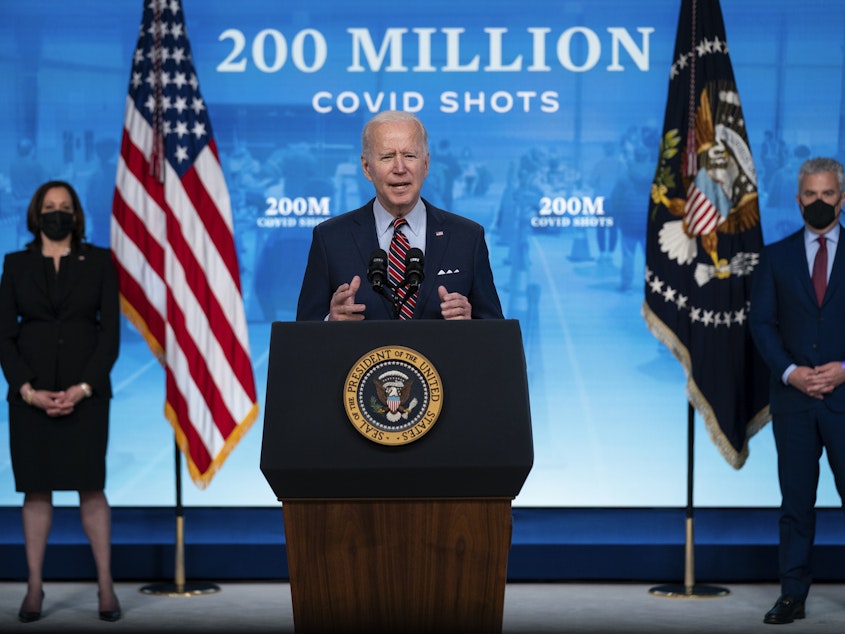 caption: President Biden appears Wednesday at the White House, where he announced his administration has reached a goal of 200 million COVID-19 shots within his first 100 days in office.