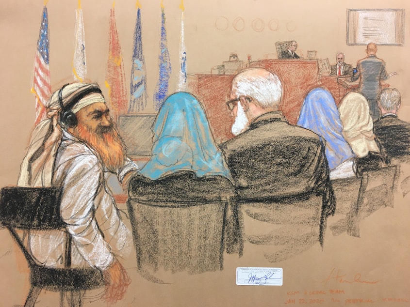 caption: Alleged Sept. 11 mastermind Khalid Sheikh Mohammed (far left) consults with his defense attorneys in the U.S. military courtroom in Guantánamo Bay, Cuba, as a man who waterboarded him, retired Air Force psychologist James Mitchell, takes the stand.