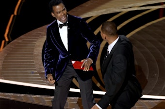 caption: Chris Rock and Will Smith are seen onstage during the 94th Annual Academy Awards at Dolby Theatre following what appeared to be an altercation.
