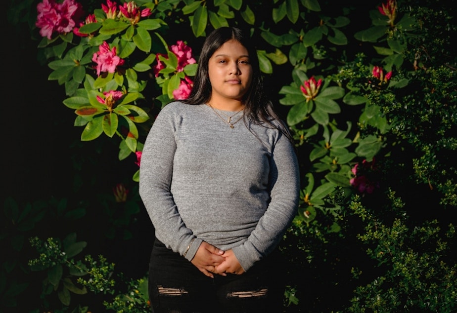 caption: Michelle Aguilar Ramirez stands for a portrait on in South Seattle, Washington, May 18, 2020.