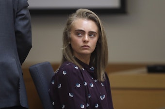 caption: In this 2017 file photo, Michelle Carter sits in a district court in Taunton, Mass. Carter was sentenced to serve 15 months in prison for involuntary manslaughter for causing her boyfriend's death.